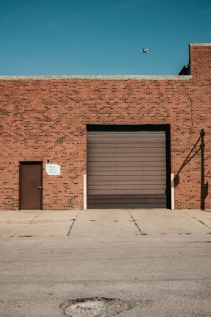 Industrial Brick Building with Airplane Overhead